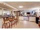 Spacious basement bar with multiple seats and a clear view into a lounge area at 233 Nome St, Aurora, CO 80010