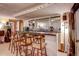Basement bar area with barstools, a mirror, and ample space for entertaining at 233 Nome St, Aurora, CO 80010