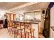 Wet bar in the finished basement includes bar seating and a prep area at 233 Nome St, Aurora, CO 80010