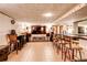 The finished basement features tile flooring, bar seating, and a lounge area with speakers at 233 Nome St, Aurora, CO 80010