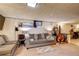 Basement Gathering room with cozy seating, a TV, and a view into bar area at 233 Nome St, Aurora, CO 80010