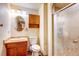 Functional bathroom with a vanity, toilet, and a stand-up shower with glass door at 233 Nome St, Aurora, CO 80010