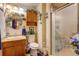 Well-lit bathroom featuring vanity, toilet, and enclosed shower, and soft decor throughout at 233 Nome St, Aurora, CO 80010