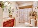 Charming bathroom with a vanity, decorative mirror, and tiled shower at 233 Nome St, Aurora, CO 80010