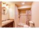 Bathroom with a standing shower and vanity, neutral color palette at 233 Nome St, Aurora, CO 80010