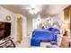 Bedroom with blue comforter, wood door, and a fan light fixture at 233 Nome St, Aurora, CO 80010