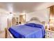 Comfortable bedroom featuring a blue bedspread, neutral walls and furniture at 233 Nome St, Aurora, CO 80010