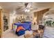 Spacious bedroom boasting plush carpeting, a ceiling fan, and soft natural light through many windows at 233 Nome St, Aurora, CO 80010
