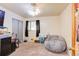 Bedroom with a bean bag, small desk and closet, offering comfort and functionality at 233 Nome St, Aurora, CO 80010