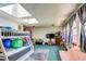 Large bonus room with bunkbeds, skylights, and a cozy lounge area perfect for entertaining at 233 Nome St, Aurora, CO 80010