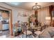 Dining area with seating for six, a modern chandelier, and views of the kitchen at 233 Nome St, Aurora, CO 80010