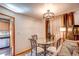 Charming dining area with a glass table and stylish chairs, complemented by warm lighting and elegant decor at 233 Nome St, Aurora, CO 80010