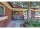 Inviting front porch with seating, showcasing the brick exterior and a view of the home's entrance at 233 Nome St, Aurora, CO 80010