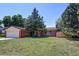 Charming brick home with a well-manicured lawn and mature trees at 233 Nome St, Aurora, CO 80010