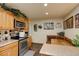 Bright kitchen featuring stainless steel appliances, light wood cabinets, and a cozy booth seating area at 233 Nome St, Aurora, CO 80010
