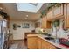Well-lit kitchen with a skylight, light wood cabinets, and a dining nook at 233 Nome St, Aurora, CO 80010