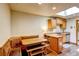 Cozy kitchen with wooden cabinets, a corner dining booth, and a skylight provides a warm and inviting space at 233 Nome St, Aurora, CO 80010