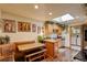 Cozy kitchen featuring a dining nook, wood cabinets, stainless steel appliances, and a bright skylight at 233 Nome St, Aurora, CO 80010
