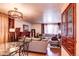 Open-concept living and dining area with hardwood floors, fireplace, and elegant furniture, perfect for entertaining at 233 Nome St, Aurora, CO 80010