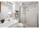 Bathroom featuring a vanity, toilet, and glass door shower with tiled walls at 1185 Yank St, Golden, CO 80401