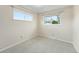 Bedroom featuring two windows letting in natural light and neutral carpet flooring at 1185 Yank St, Golden, CO 80401