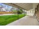 A covered patio with black metal pillars that overlooks the property's green, grassy backyard at 1185 Yank St, Golden, CO 80401