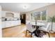 Eat-in kitchen with white cabinets, wood floors, and a view to the backyard at 1185 Yank St, Golden, CO 80401