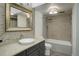 Elegant bathroom with a vessel sink, unique mirror, and tiled shower at 460 S Marion Pkwy # 706, Denver, CO 80209