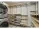 Walk-in closet featuring shelving and a stackable washer and dryer at 460 S Marion Pkwy # 706, Denver, CO 80209