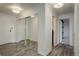 Hallway featuring wood flooring, closet with mirrored doors, and access to the bathroom at 460 S Marion Pkwy # 706, Denver, CO 80209