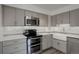 The remodeled kitchen includes stainless steel appliances and gray cabinets at 460 S Marion Pkwy # 706, Denver, CO 80209