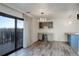 Open living room with bar area, cabinets, wine fridge, and sliding glass doors at 460 S Marion Pkwy # 706, Denver, CO 80209