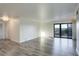 Bright, airy living room featuring wood floors and a sliding glass door to the balcony at 460 S Marion Pkwy # 706, Denver, CO 80209