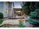 Stone patio with a fire pit and a covered patio with seating makes for an inviting outdoor living space at 4649 Spinning Wheel Dr, Brighton, CO 80601