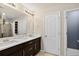 Bathroom featuring a double vanity, framed mirrors, modern lighting, and neutral wall color at 4649 Spinning Wheel Dr, Brighton, CO 80601