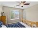 A cozy bedroom with natural light, a ceiling fan, and a dresser, creating a comfortable and inviting atmosphere at 4649 Spinning Wheel Dr, Brighton, CO 80601