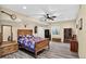 Spacious bedroom features wood floors, a ceiling fan, and rustic wood furniture at 4649 Spinning Wheel Dr, Brighton, CO 80601