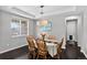 Formal dining room with hardwood floors, modern lighting, and table for six at 4649 Spinning Wheel Dr, Brighton, CO 80601