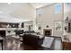 Spacious living room with a fireplace, hardwood floors, and plenty of natural light coming through the large windows at 4649 Spinning Wheel Dr, Brighton, CO 80601