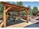 Covered outdoor dining area featuring stone counters, stainless appliances and dining for six at 4649 Spinning Wheel Dr, Brighton, CO 80601
