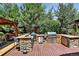 Outdoor kitchen with stainless steel grill, stone counters and wooden deck perfect for entertaining at 4649 Spinning Wheel Dr, Brighton, CO 80601