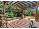 Backyard patio with timber pergola, stone columns, built in seating, and a fire pit at 4649 Spinning Wheel Dr, Brighton, CO 80601