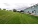 Expansive backyard with lush green grass and a row of townhomes at 19249 E 58Th Ave # D, Denver, CO 80249