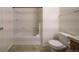Bathroom features a tiled shower-tub combination and a toilet at 19249 E 58Th Ave # D, Denver, CO 80249