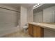 Bright bathroom featuring a shower-tub combination, vanity, and tile flooring at 19249 E 58Th Ave # D, Denver, CO 80249