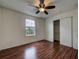 Bedroom with wood-look floors, a ceiling fan, a window and a closet at 19249 E 58Th Ave # D, Denver, CO 80249