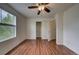 Bright bedroom with wood-look floors, a ceiling fan, a window and a closet at 19249 E 58Th Ave # D, Denver, CO 80249