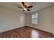 Bedroom with wood-look floors, a ceiling fan, and a window at 19249 E 58Th Ave # D, Denver, CO 80249