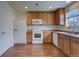Well-lit kitchen with stainless steel appliances, wooden cabinets, and ample counter space at 19249 E 58Th Ave # D, Denver, CO 80249