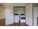 A laundry closet with shelving and side by side washer and dryer units behind folding doors at 19249 E 58Th Ave # D, Denver, CO 80249